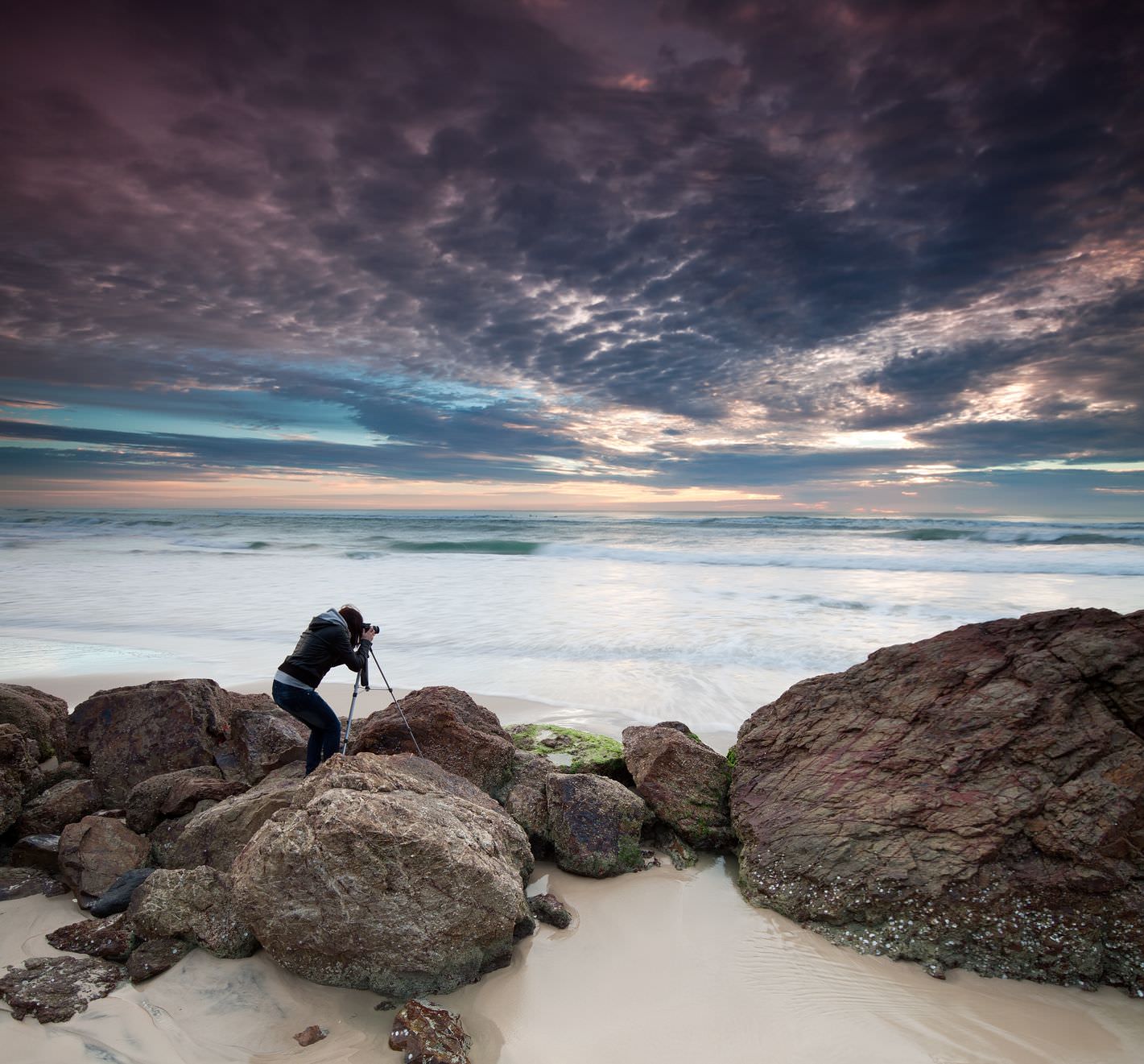 photographer shooting a seascape image 