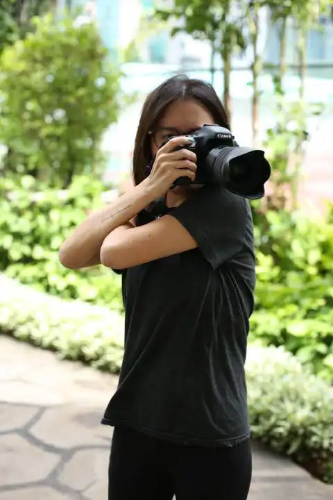 Portrait of a Photographer Holding a Camera · Free Stock Photo