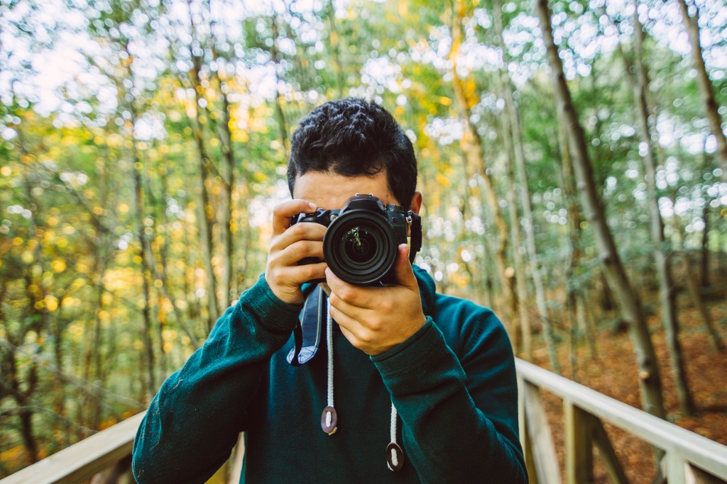 young man using dslr camera picture id496915388 image 