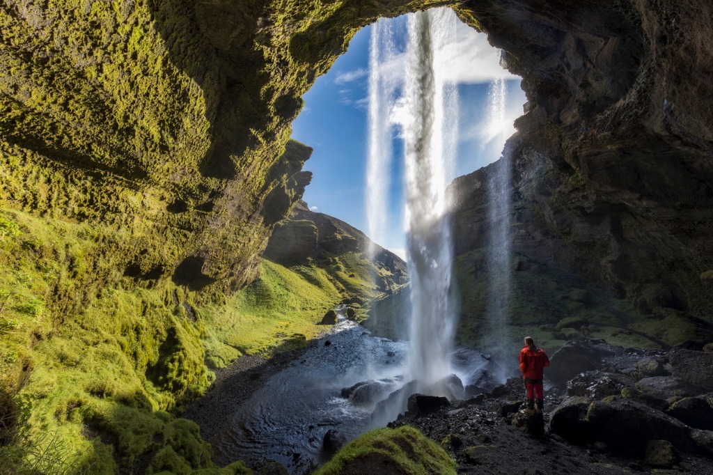 hiker at majestic kvernufoss waterfall in iceland picture id853423076 image 