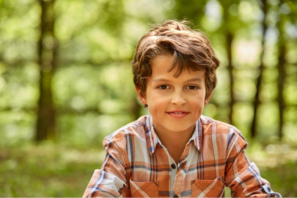 portrait of smiling boy against trees in forest picture id800406836 image 