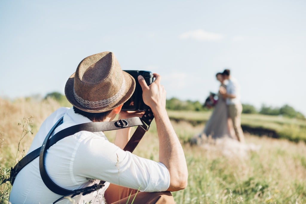 wedding photographer takes pictures of bride and groom in nature fine picture id802955798 image 