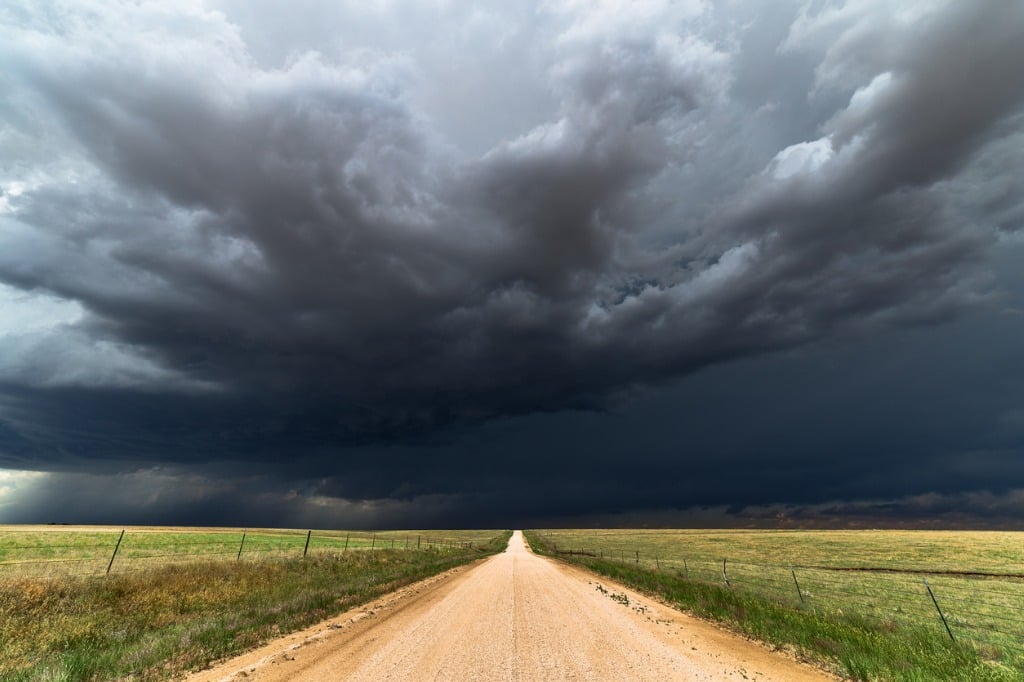 dark storm clouds over a dirt road picture id811485572 image 