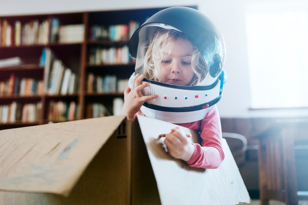 children imagine space adventure in cardboard box picture id875850924