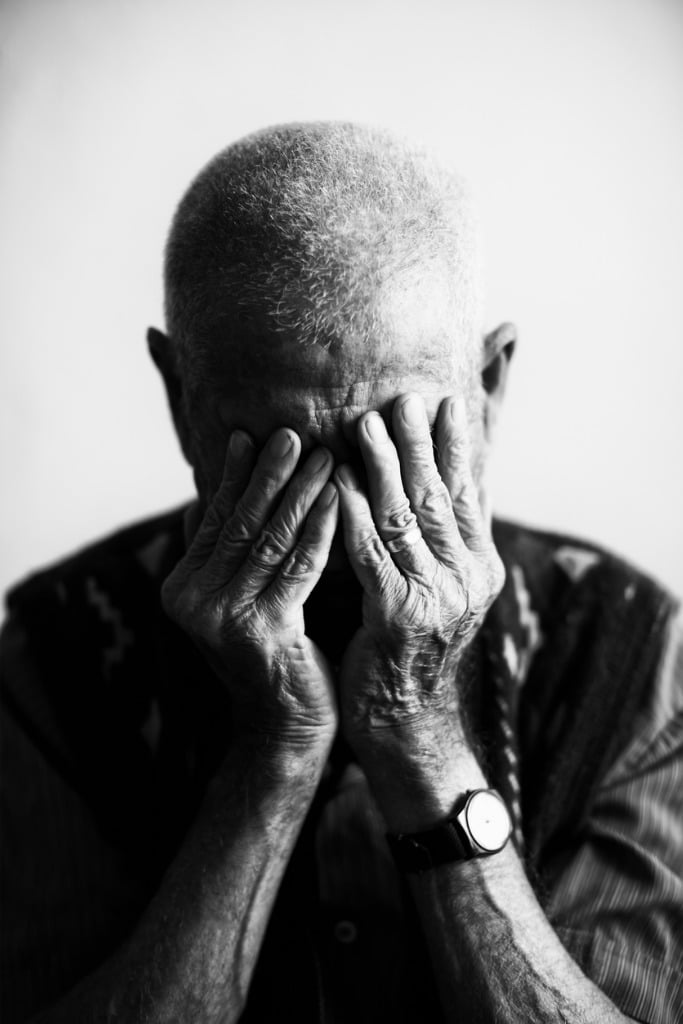 an old man covering his face with his hands in grief picture id181888757 image 